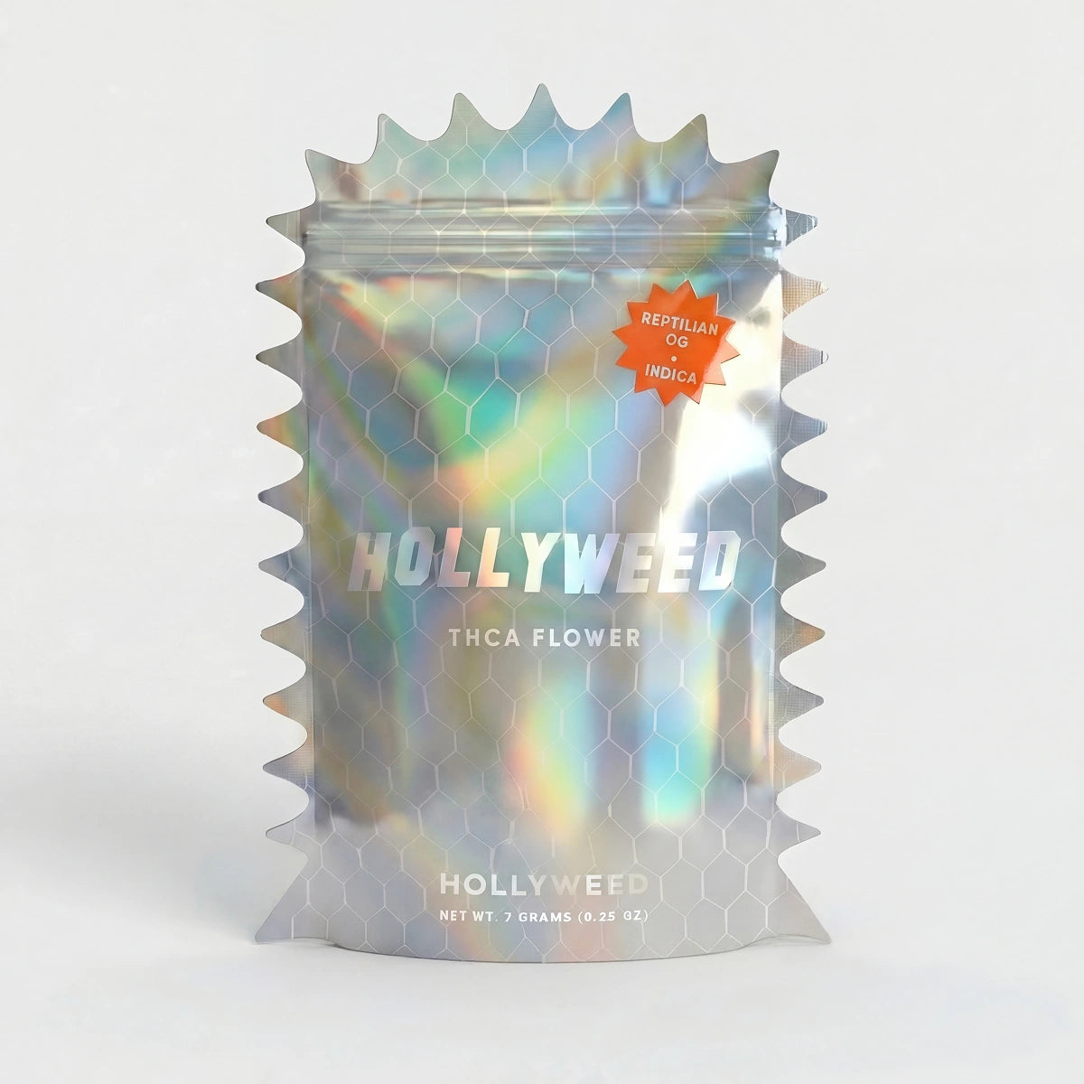 Hollyweed Reptilian OG THCA flower in a 7g mylar bag, showcasing dense indica buds with vibrant green and orange pistils.