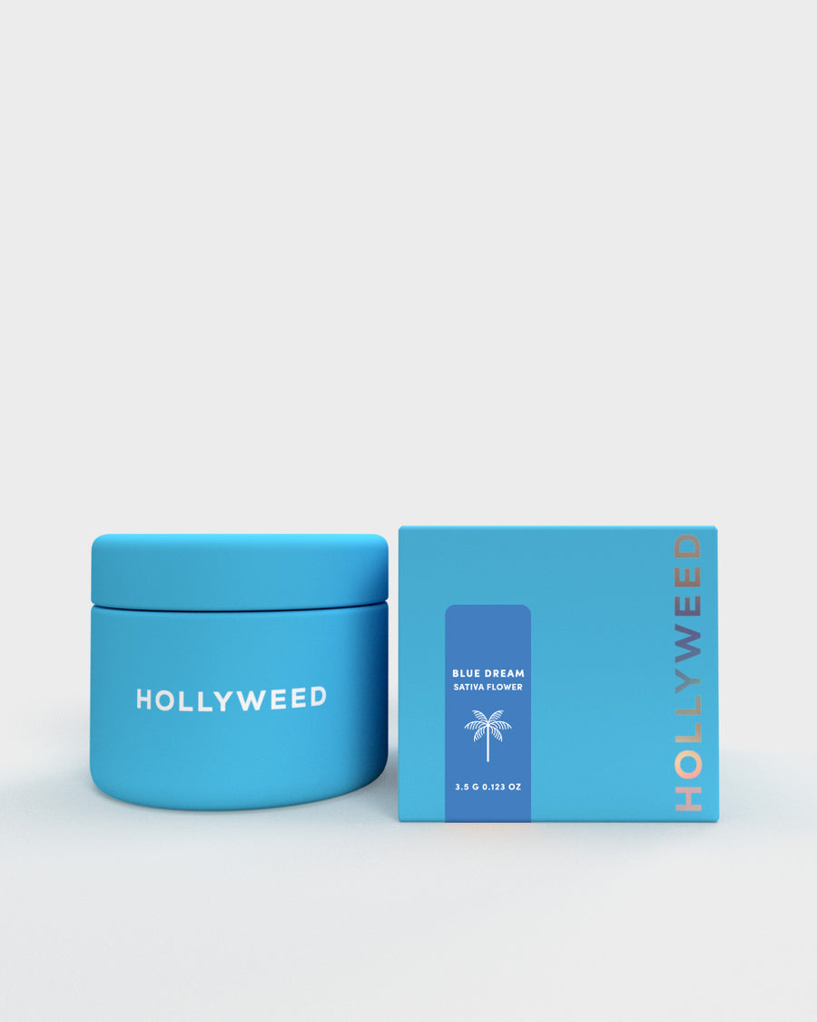 Hollyweed Blue Dream THCA flower in a jar and box, showcasing vibrant sativa buds with orange hairs and green leafy texture.