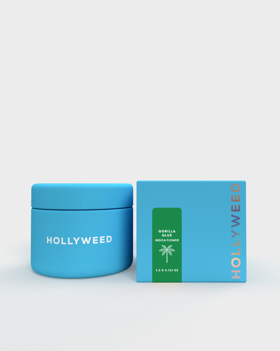 Hollyweed THCA flower Gorilla Glue strain in a jar and box, showcasing dense, green indica buds with orange hairs and trichomes.