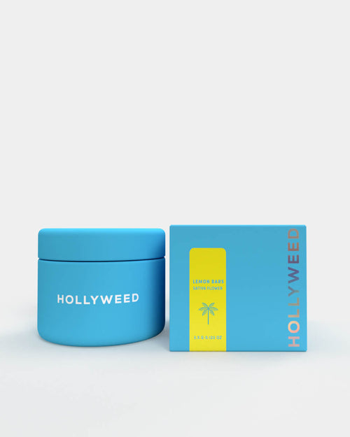 Hollyweed THCA Flower Lemon Bars strain in a jar and box, showcasing vibrant sativa cannabis buds with yellow-orange hues.
